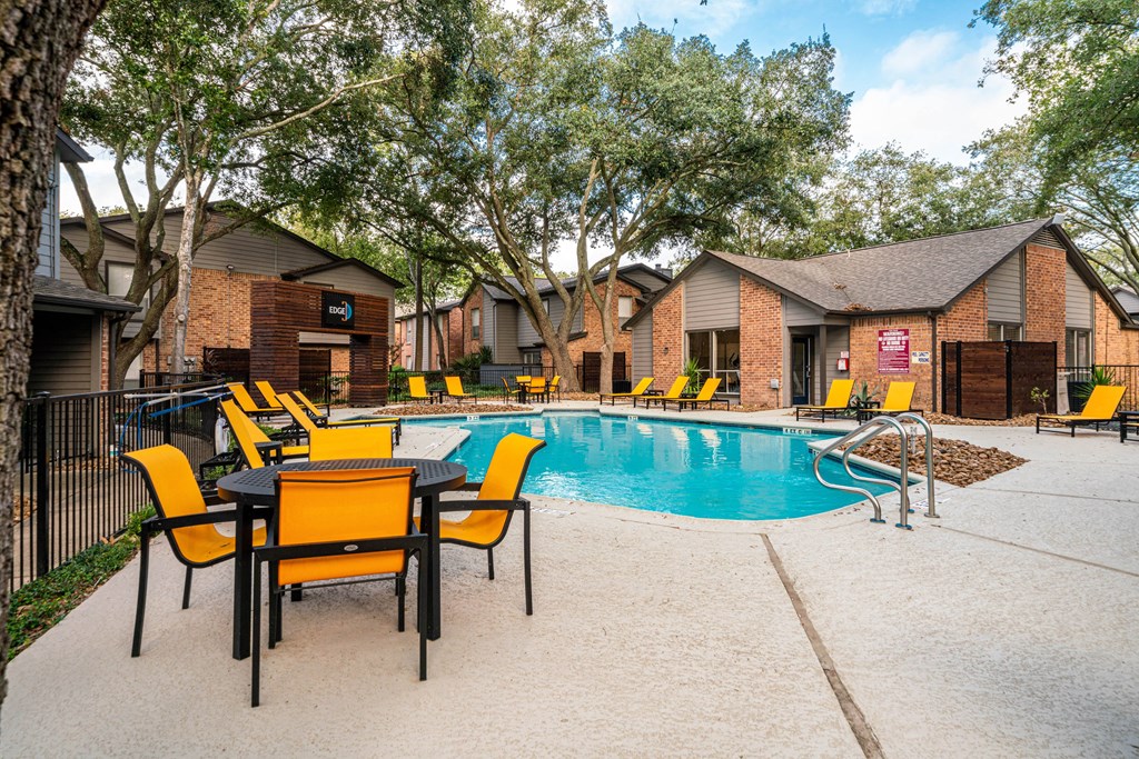 our apartments have a pool and a patio with chairs