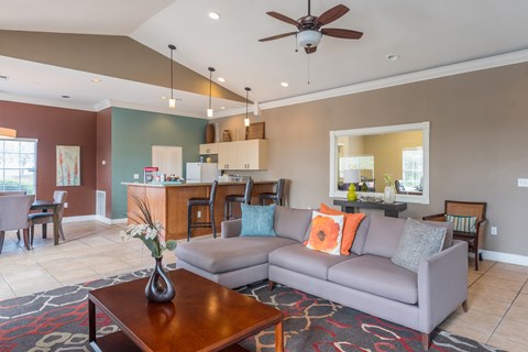 A living room with a grey couch and a wooden coffee table.