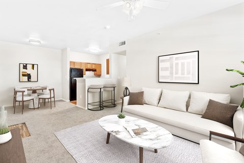 A living room with a white couch and a coffee table.