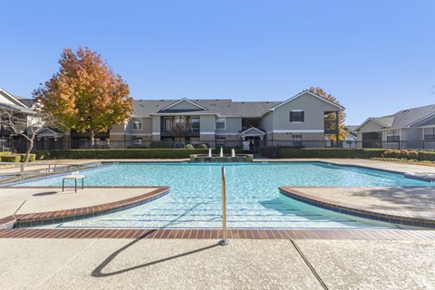 A swimming pool in front of a residential building.