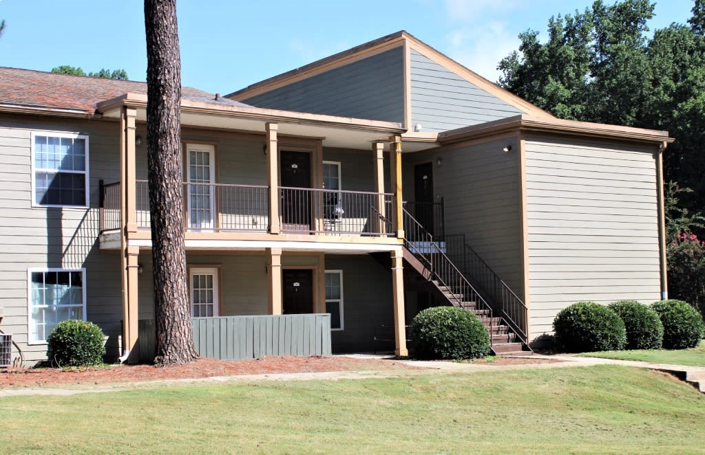 A two-story house with a balcony on the second floor at Clarkston Station Apartments, Clarkston, GA