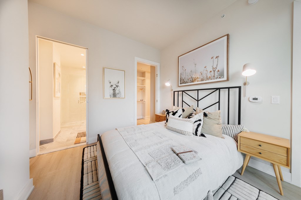 a bedroom with a large bed and a door to a bathroom