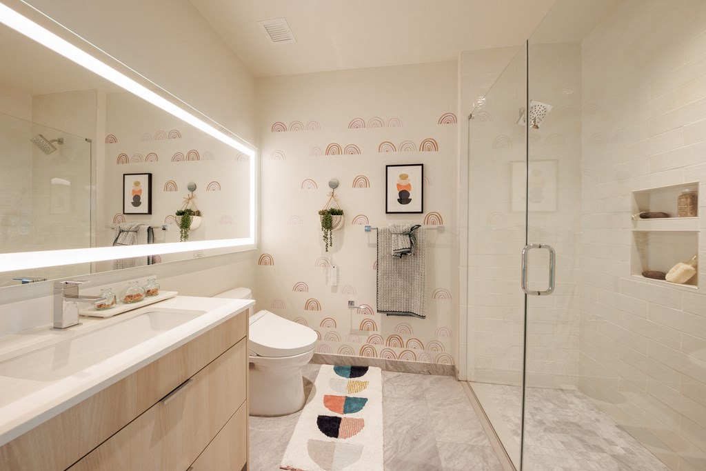 a bathroom with a shower and a sink and a toilet