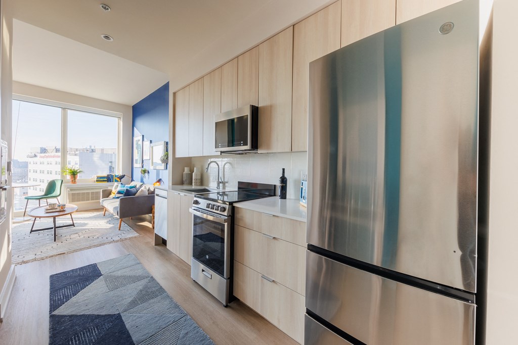 a kitchen with stainless steel appliances and a large window