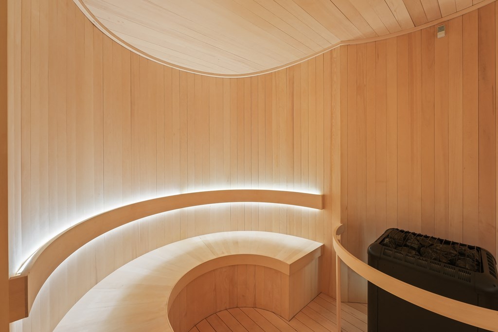 a large wooden spiral staircase in a wood paneled room