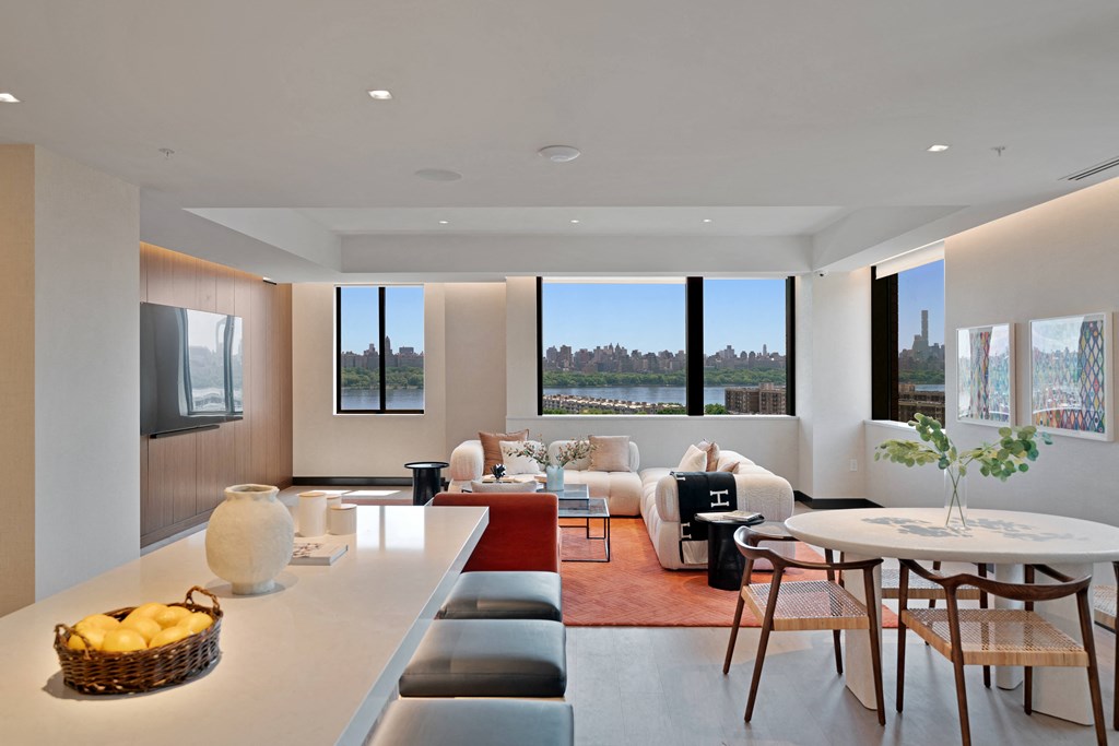 a living room and dining room with a table and chairs