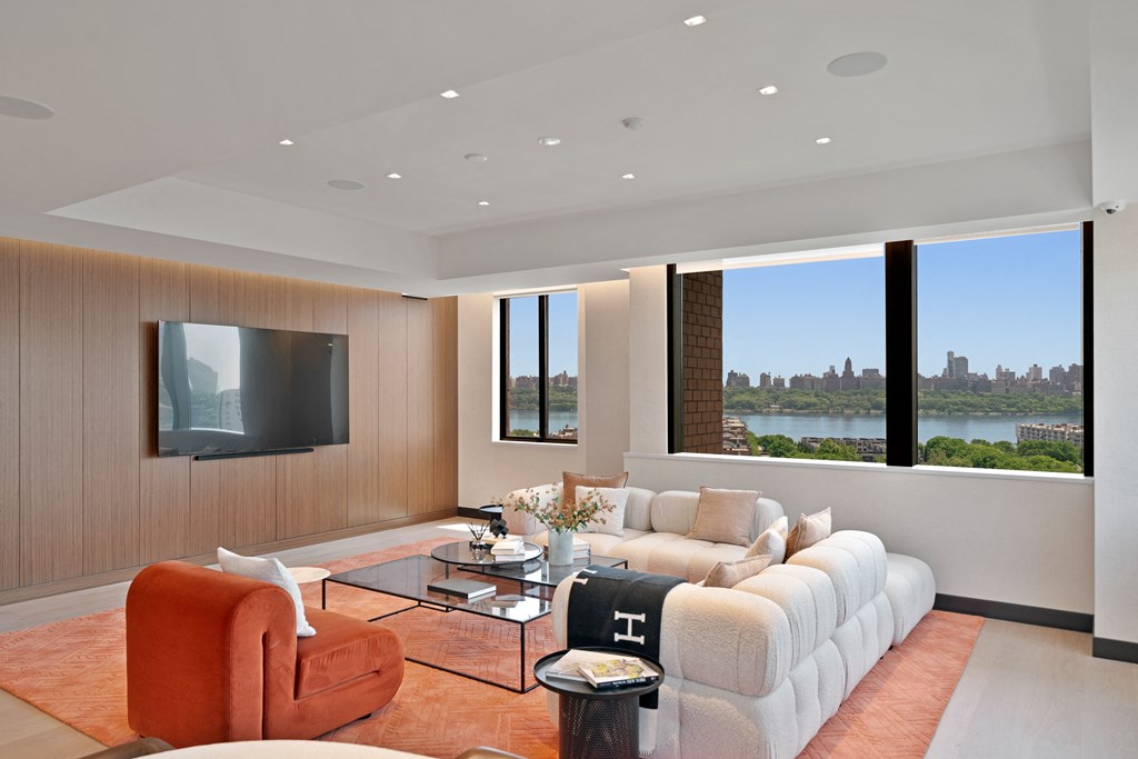 a living room with a couch and a coffee table and a television