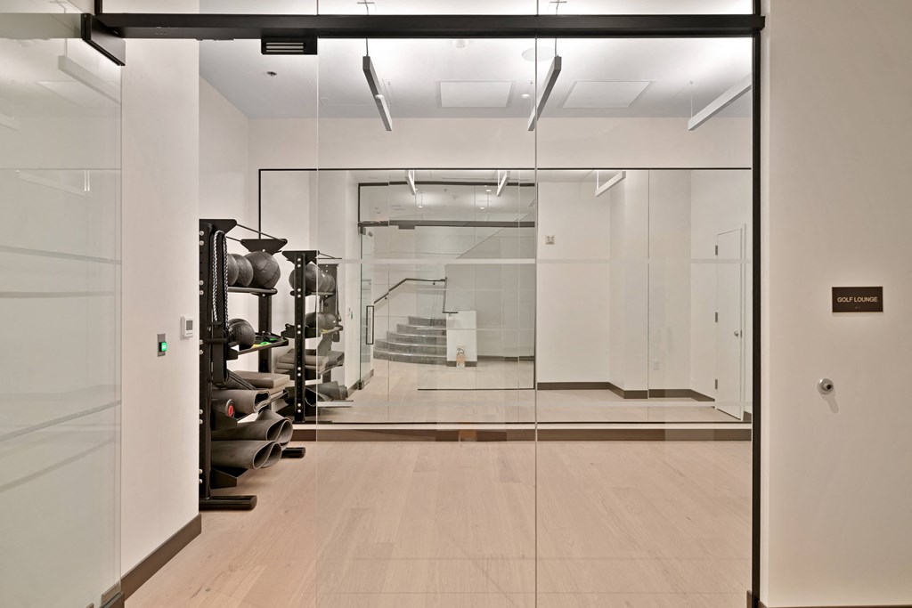 a large room with glass walls and a collection of vases on display