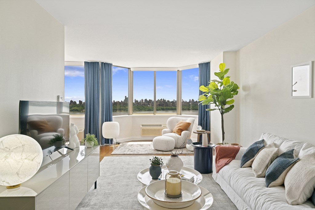 a living room with a white couch and a large window
