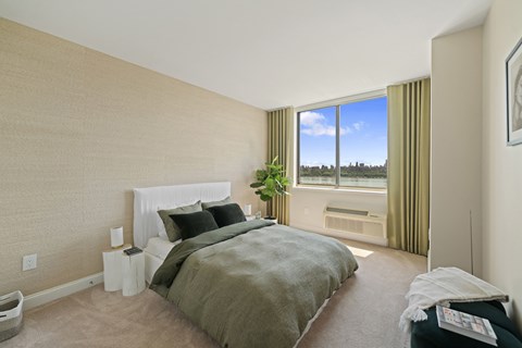 a bedroom with a bed and a large window