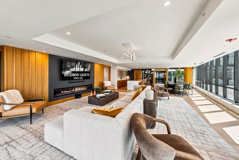 A modern living room with a fireplace and a large couch.