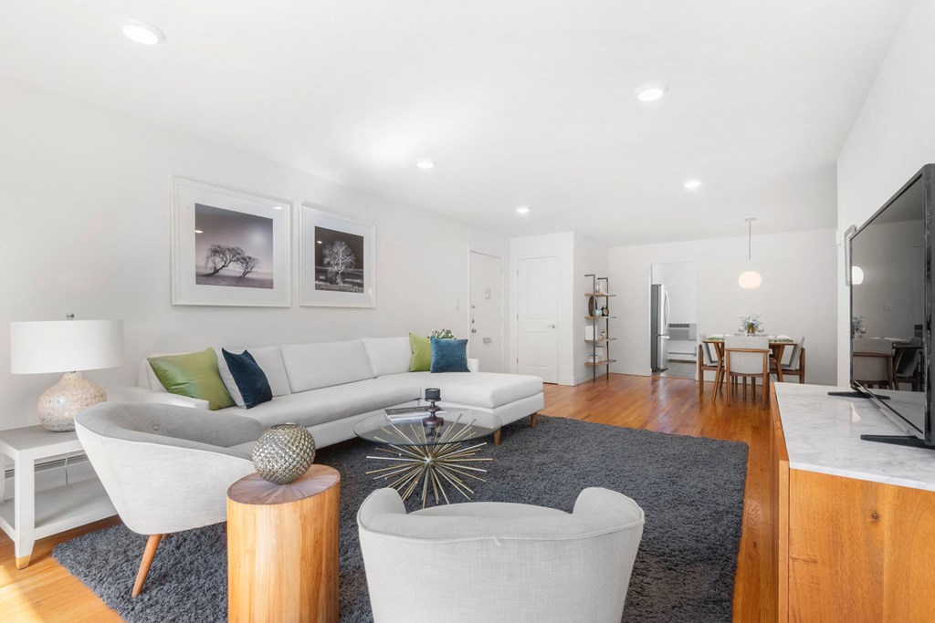 a living room with a couch and two chairs 1 bedroom