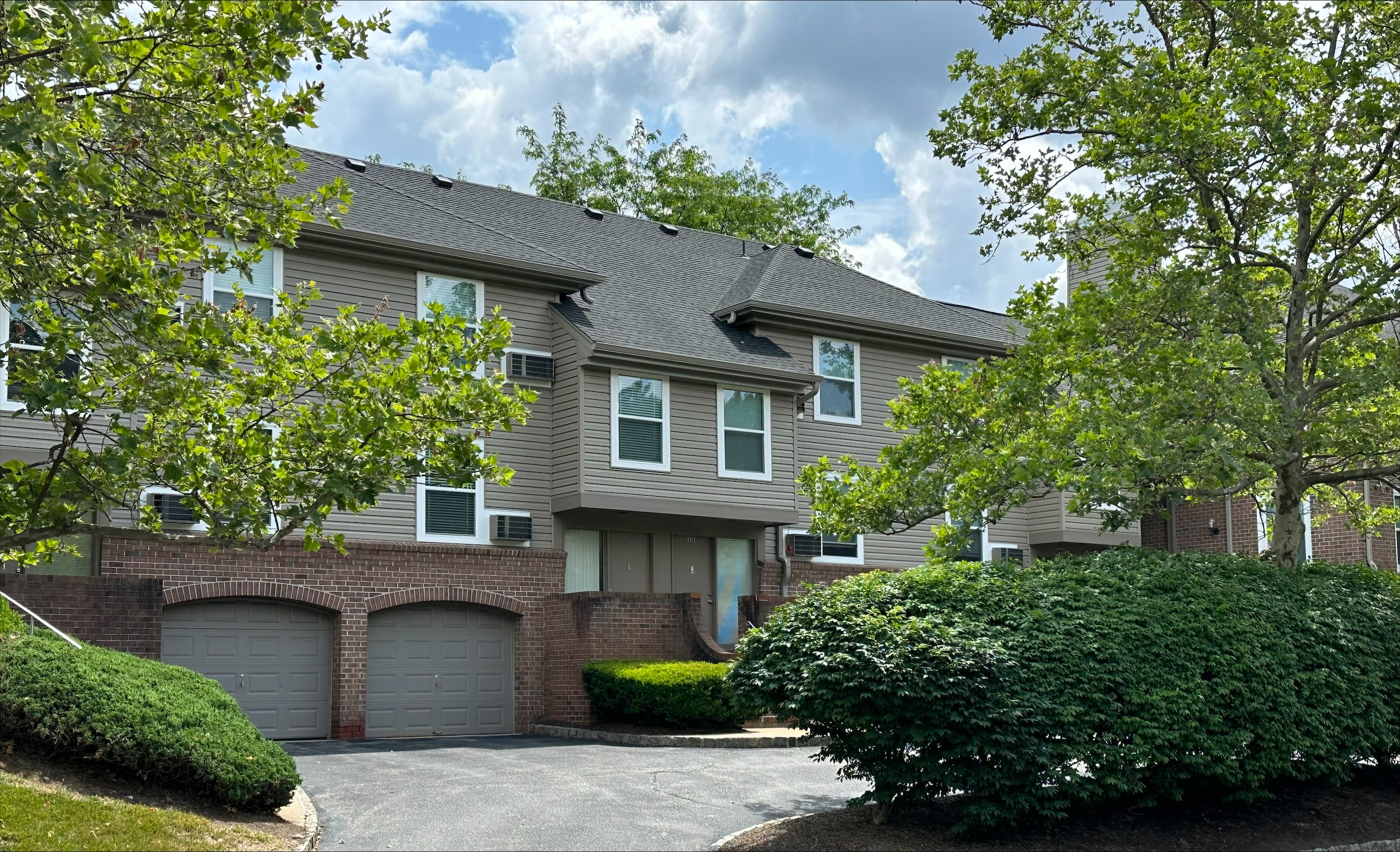 a large apartment complex with two garages at Everly Roseland, Roseland, New Jersey