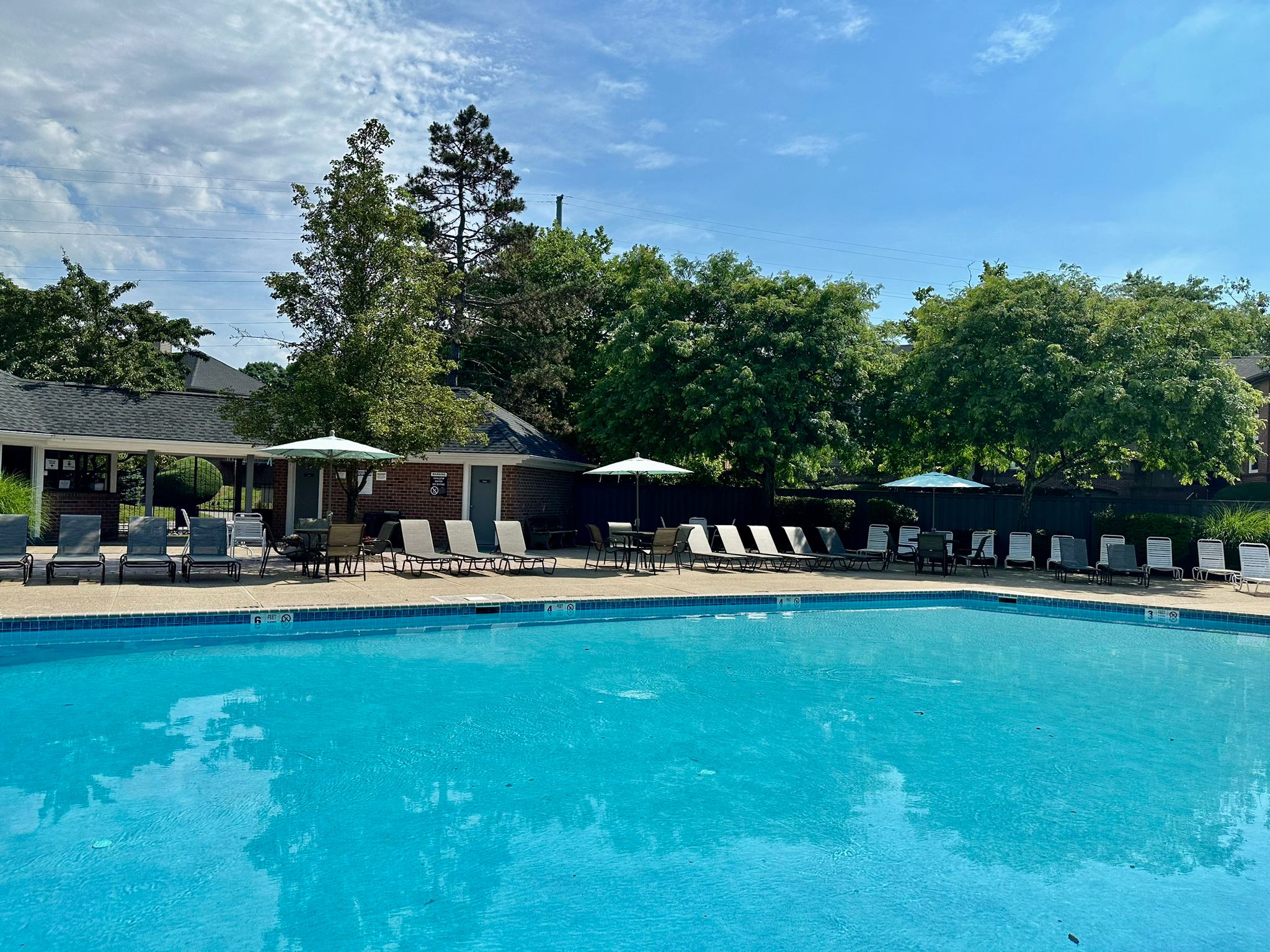 a swimming pool with chairs and umbrellas at a resort