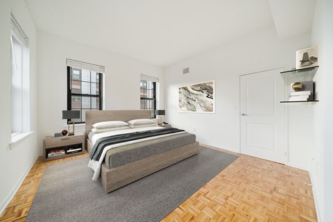 A bedroom with a large bed and a window.