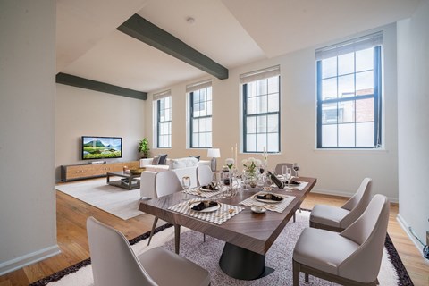 A modern dining room with a wooden table and chairs.