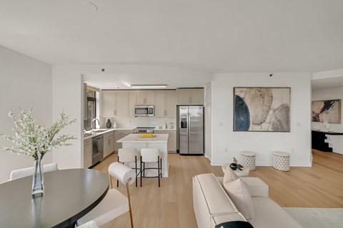 A modern kitchen with a dining table and chairs.