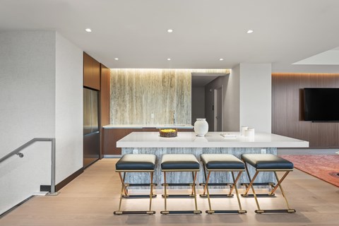 A modern dining room with a long table and chairs.