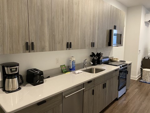A kitchen with wooden cabinets and a white countertop.