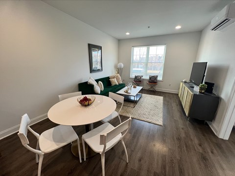 A dining room with a white table and chairs.