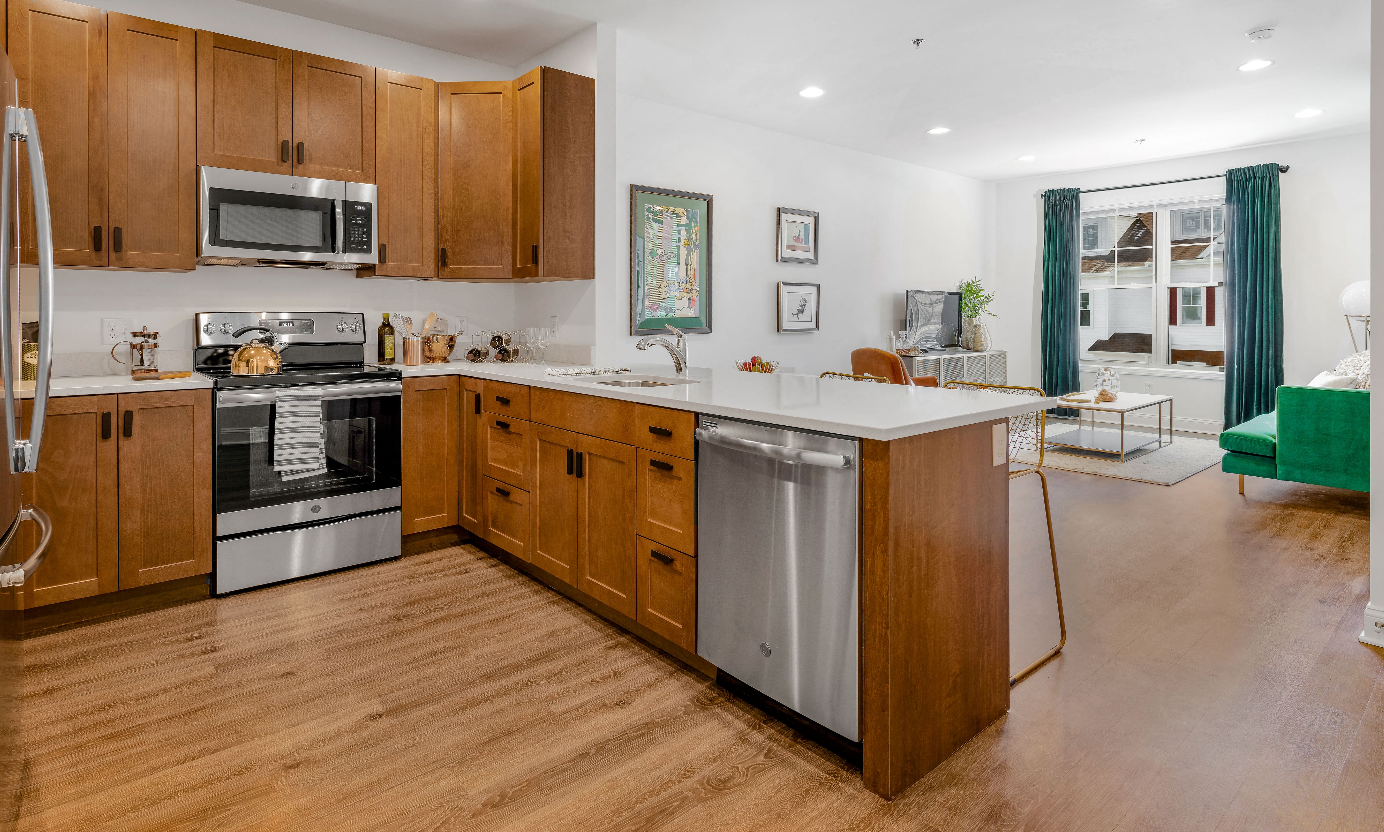 A kitchen with wooden cabinets and a stainless steel dishwasher.