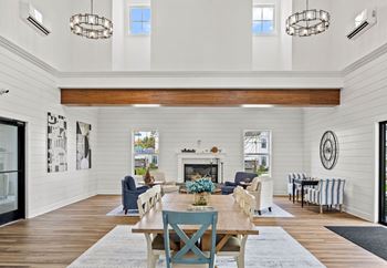 A dining room with a wooden table and chairs.