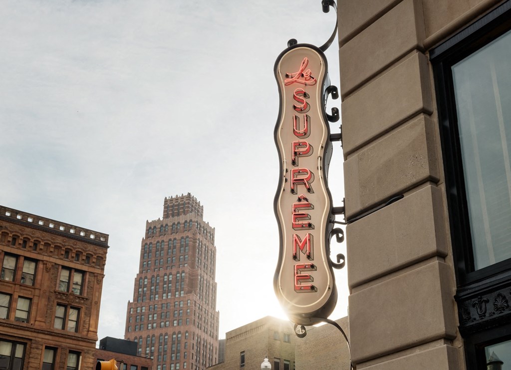 a neon sign on the side of a building in the cityat Book Tower, Detroit, Michigan