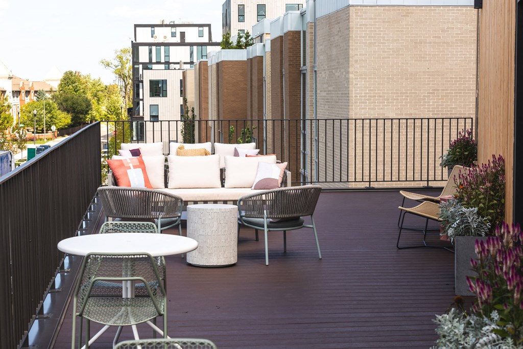 A patio with a white table and chairs.