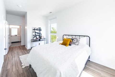 a bedroom with a bed and a window