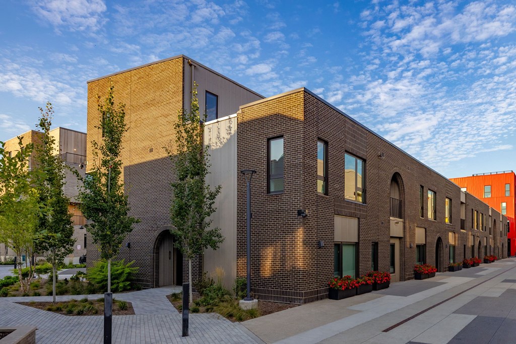 A long building with a lot of windows and a brick facade.