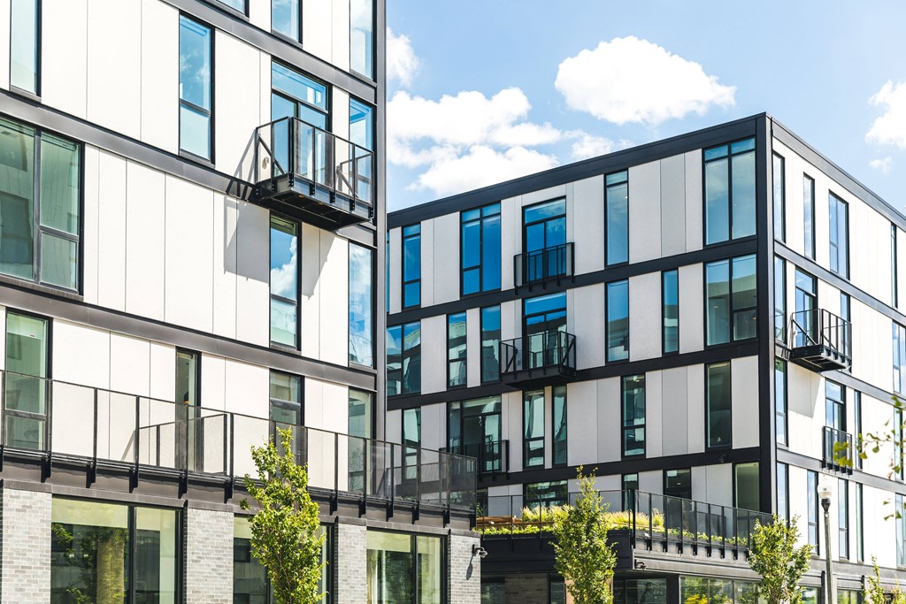 A modern building with balconies and glass windows.