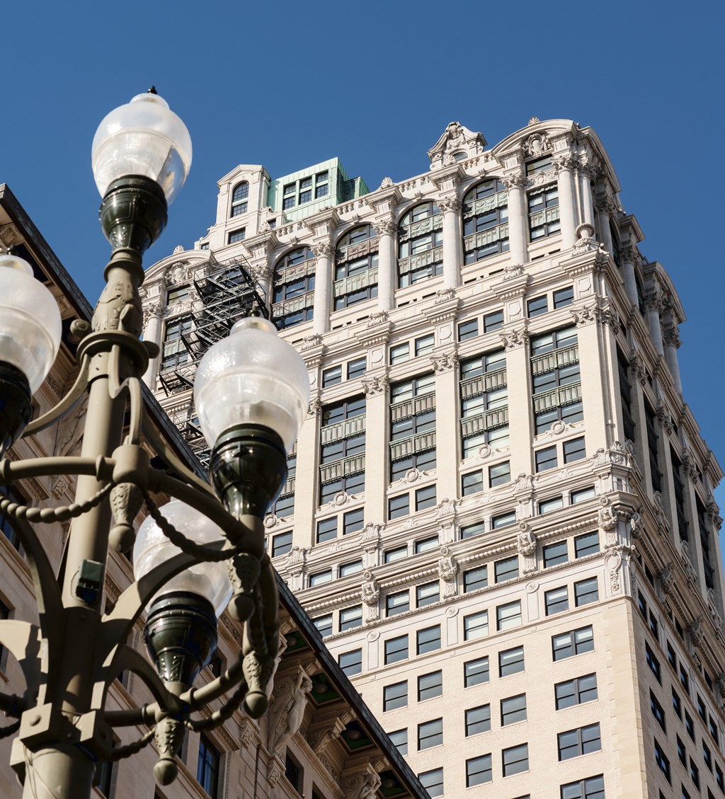 a street light in front of a tall buildingat Book Tower, Detroit, MI