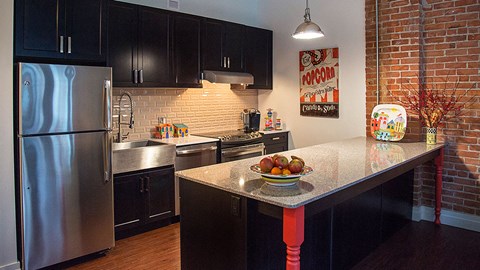 a kitchen with stainless steel appliances and a granite counter top