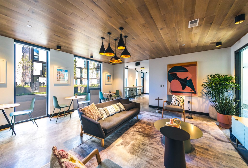 a living room filled with furniture and a large window