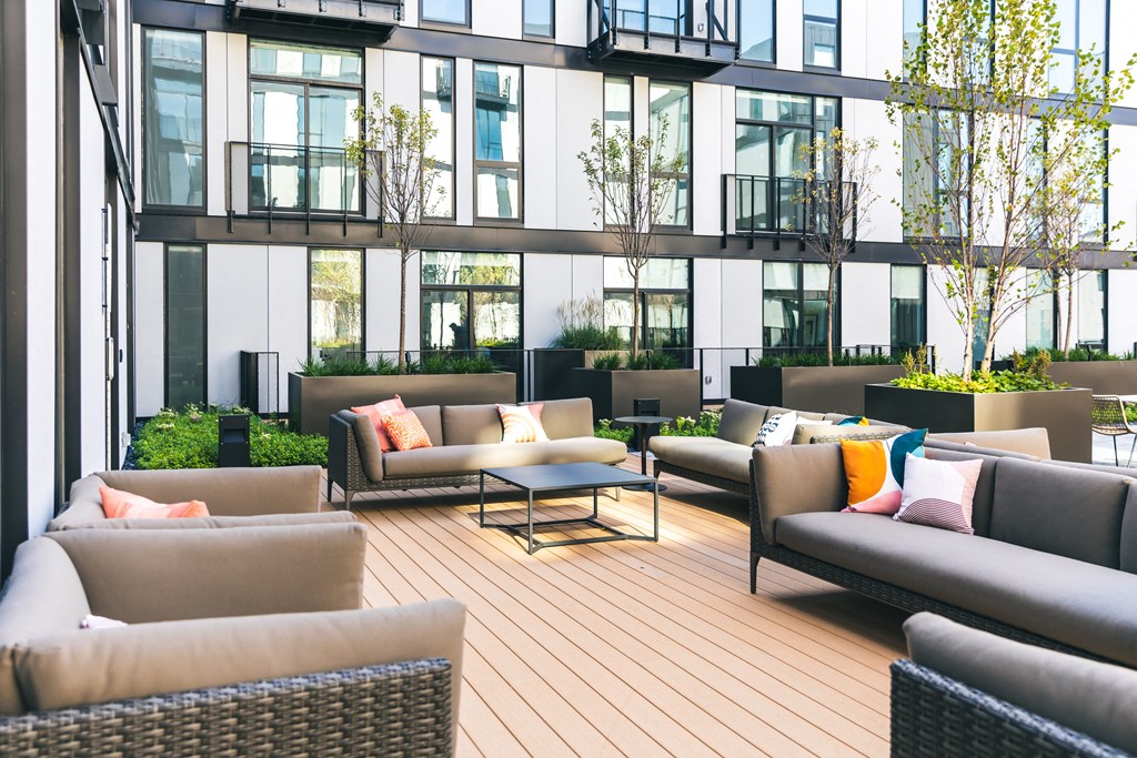 a seating area with couches and tables on a patio