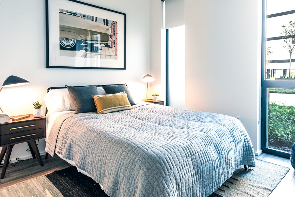 a bedroom with a large bed and a large window