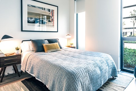 a bedroom with a large bed and a large window