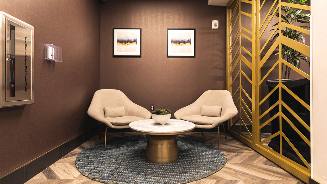 Chair and Center table with Wall frames background at The Ferguson Downtown Detroit Apartments, Detroit, MI