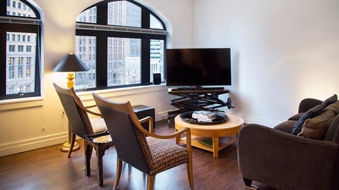 a living room with a table and chairs and a television