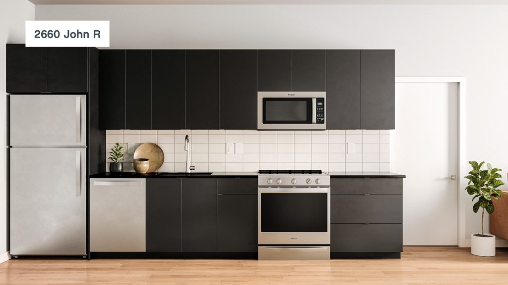 a kitchen with black cabinets and stainless steel appliances