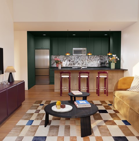 A modern kitchen with green cabinets and a bar area.