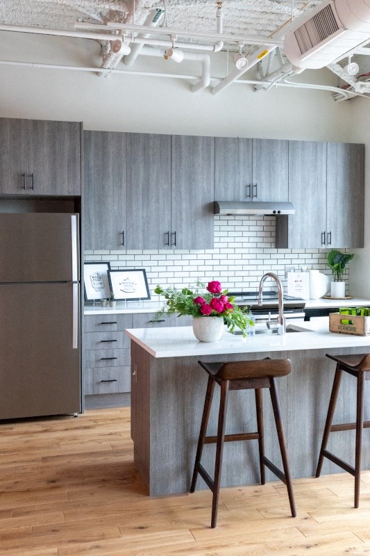 Kitchen with Island and Grey Cabinets at The Assembly, Detroit, MI