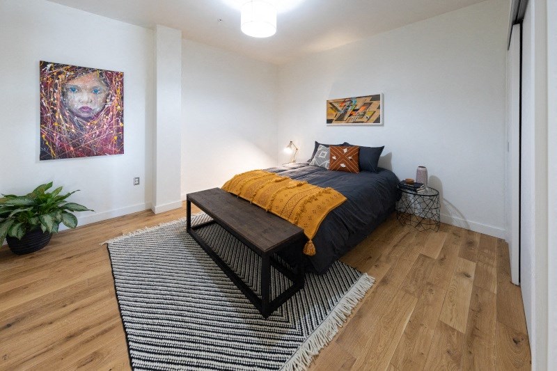 Bedroom with a Grey Bed and Wall Painting at The Assembly, Detroit, MI