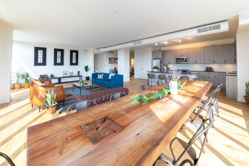 Wooden Table in a Large Room with Couches at The Assembly, Detroit, MI