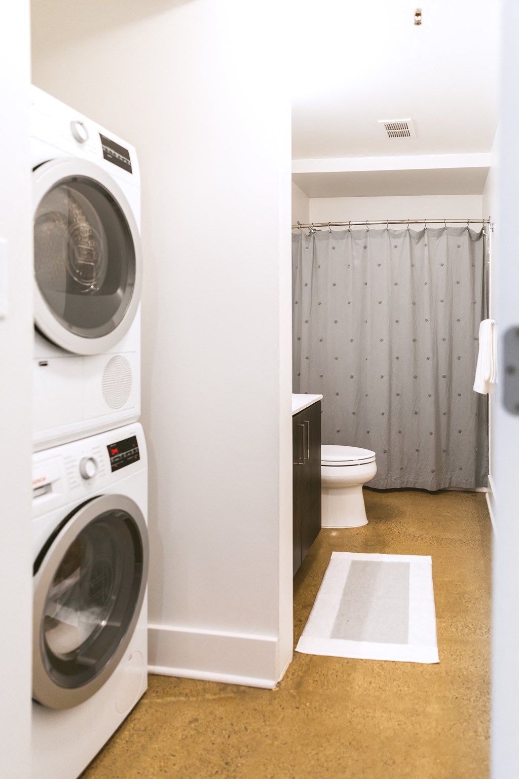 a bathroom with a washer and dryer and a toilet at The Ferguson Apartments, Detroit, MI
