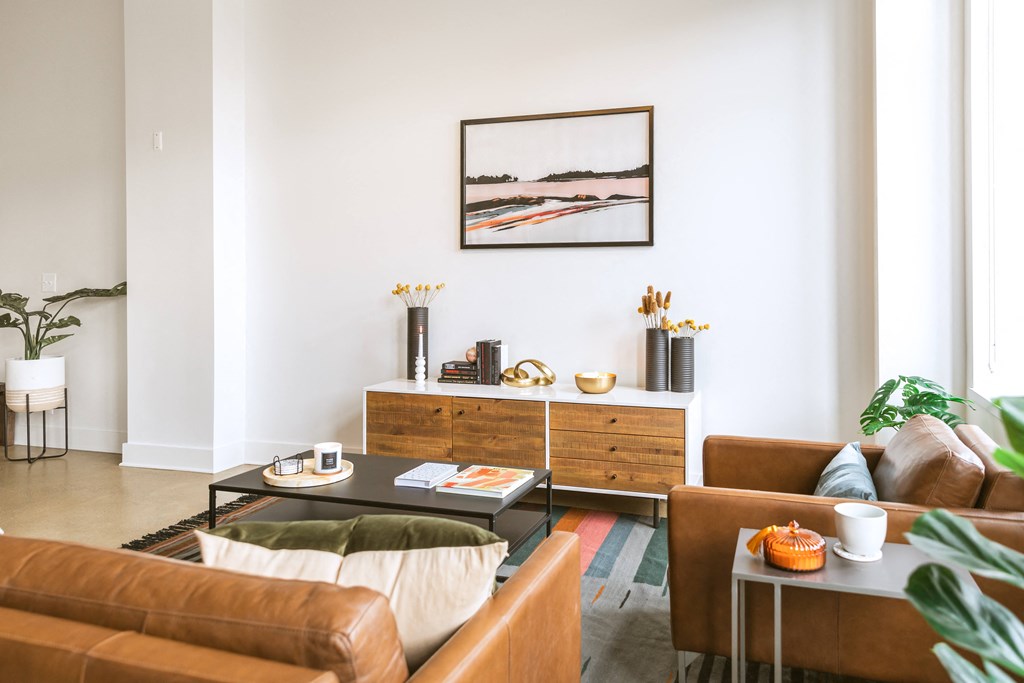 a living room with white walls and brown leather furniture  at The Ferguson, Michigan