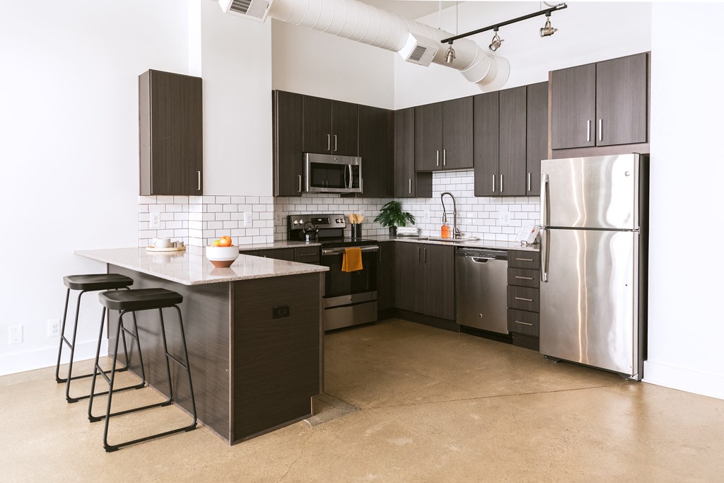 a kitchen with a large island and stainless steel appliances at The Ferguson Apartments, Detroit, 48226