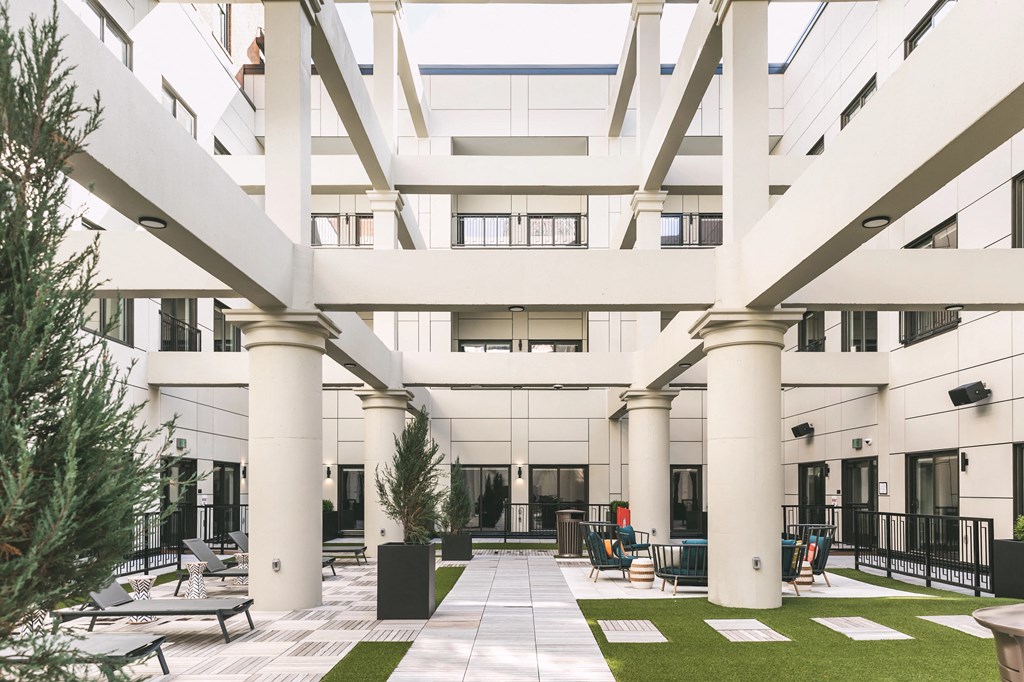 Outdoor community atrium with seating and built-in fire pits at The May.