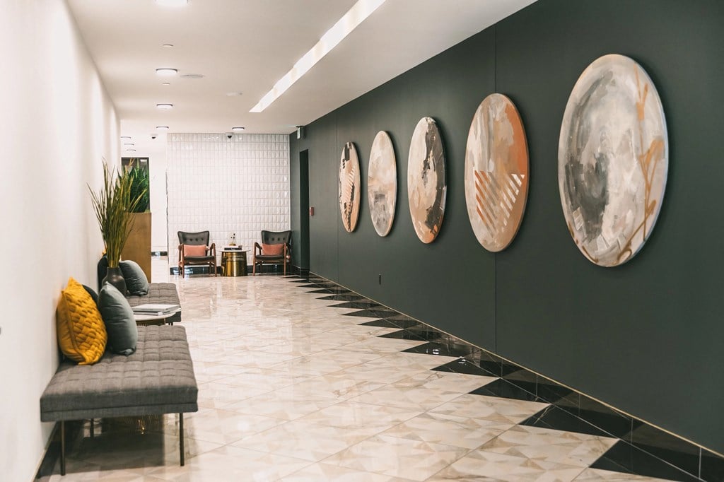 Interior hallway with modern furnishings and elegant artwork at The May.