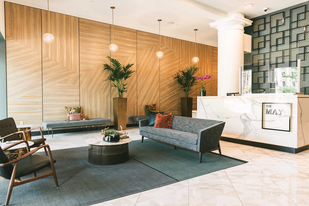 A lobby featuring luxurious wood paneling, elegant lighting, and modern furnishings.